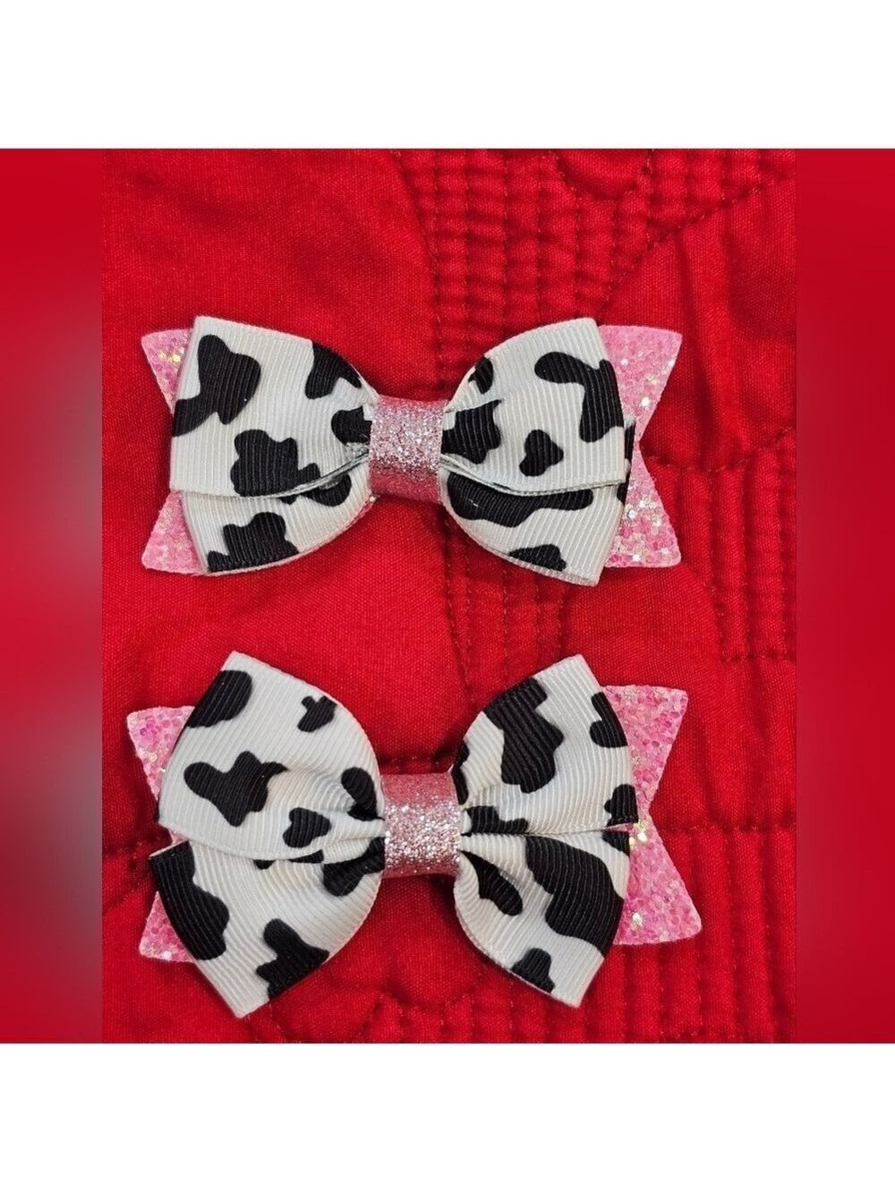 One pair of cow print pink sparkly hair bows